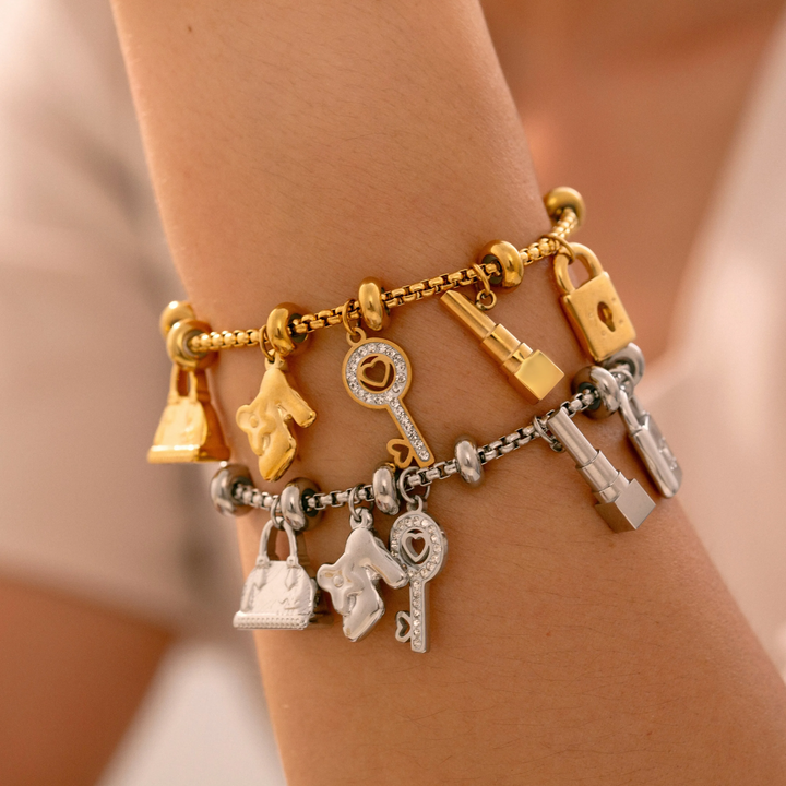 Women's adjustable charm bracelet featuring gold & silver tones & shimmering rhinestone details. Elegant.