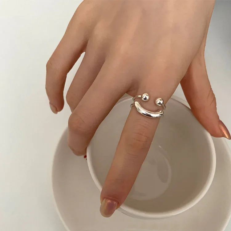 Fashionable adjustable gold smiley face ring, a cheerful and versatile accessory for everyday wear.