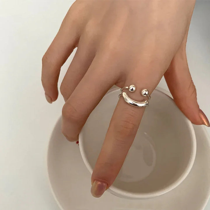 Fashionable adjustable gold smiley face ring, a cheerful and versatile accessory for everyday wear.