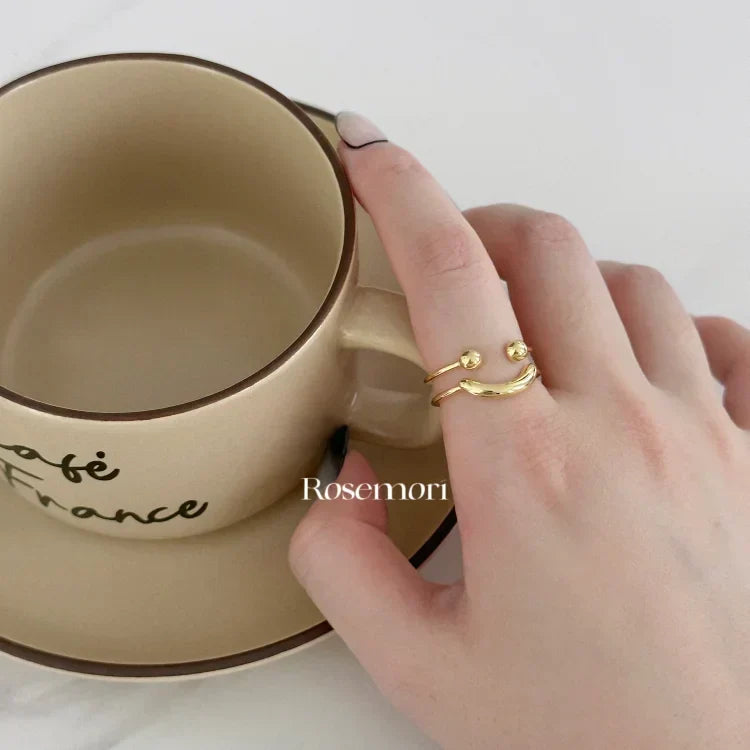 Trendy adjustable smiley face ring for women, a comfortable and stylish gold or silver fashion accessory.