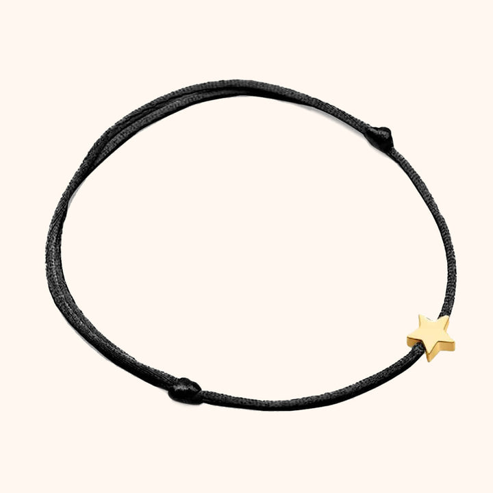 Women's adjustable nylon bracelet with a delicate silver-tone star charm. Perfect everyday jewelry.