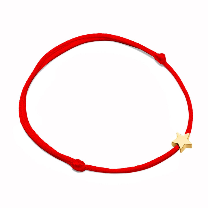 Delicate women's gold star charm bracelet, featuring an adjustable nylon cord for a perfect fit.
