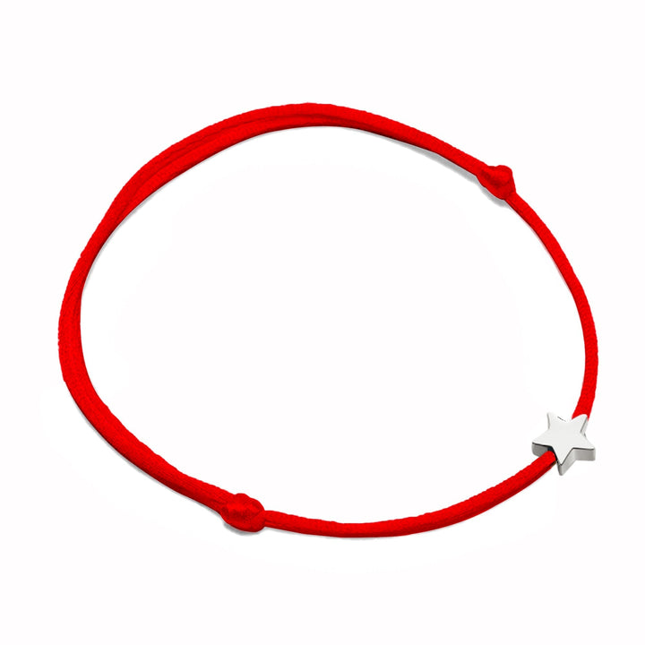 Chic women's accessory: An adjustable nylon bracelet with a gleaming metal star charm.