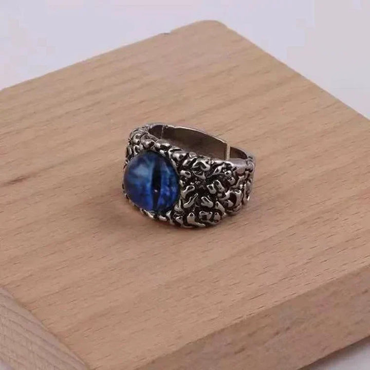 Women's adjustable silver snake ring with a striking green demon eye, unique gothic punk jewelry.