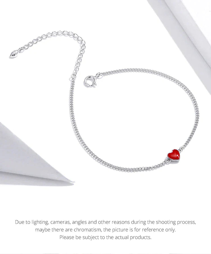 Versatile women's adjustable sterling silver bracelet, adorned with a bold red heart charm. Great for daily wear.