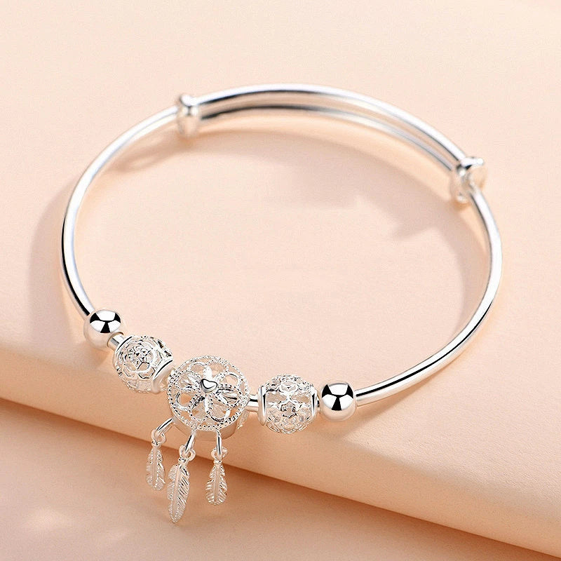 Symbolic women's adjustable dreamcatcher bracelet, crafted from gleaming sterling silver, a meaningful gift.