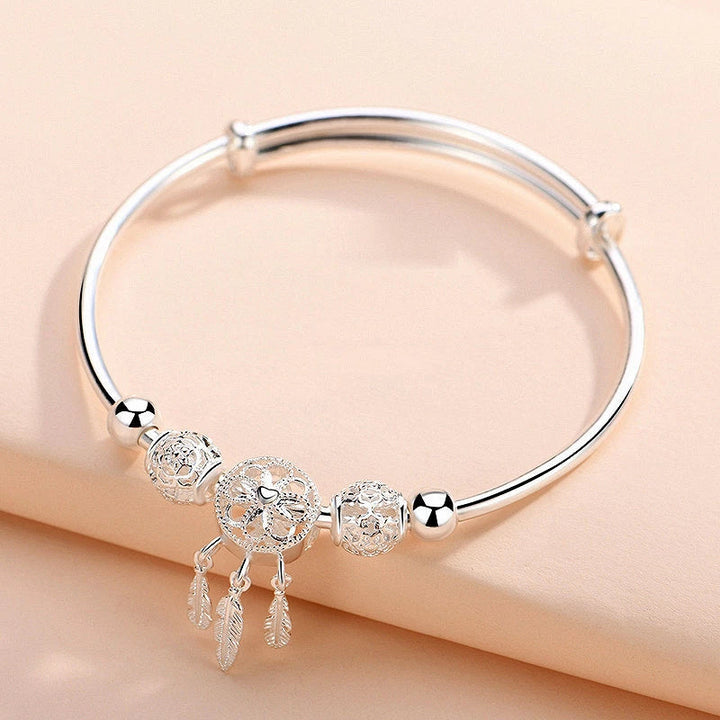 Symbolic women's adjustable dreamcatcher bracelet, crafted from gleaming sterling silver, a meaningful gift.
