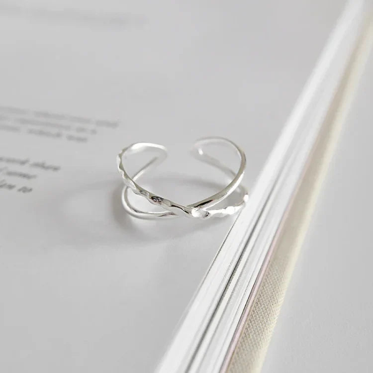 Women's adjustable sterling silver ring with a modern double line design, perfect for everyday wear.