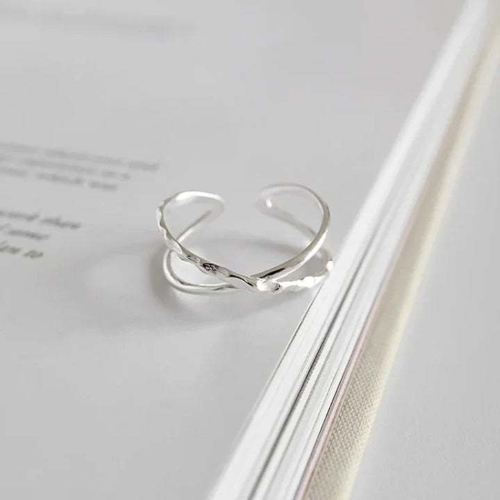 Women's adjustable sterling silver ring with a modern double line design, perfect for everyday wear.