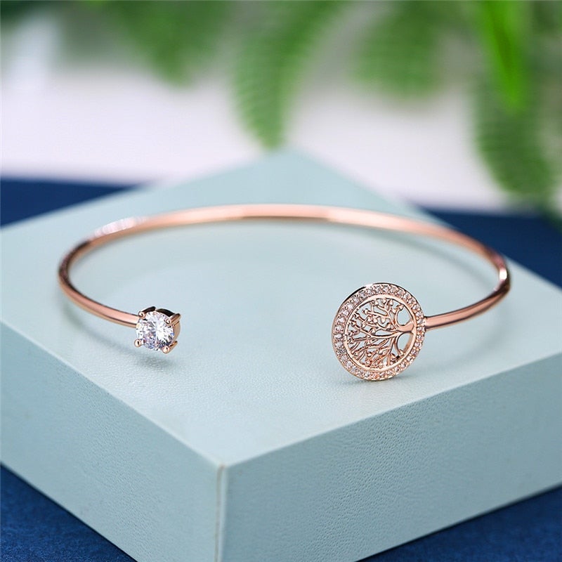 Close-up of a symbolic Tree of Life charm on an adjustable women's bracelet. Meaningful silver jewelry.