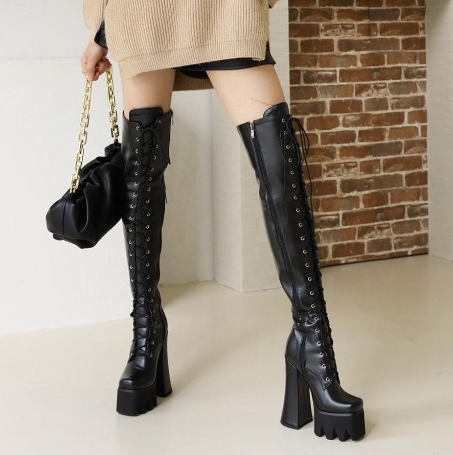 Edgy Women's Adora platform knee boots with high heel. Comfortable, waterproof, and sleek for bold versatile style.