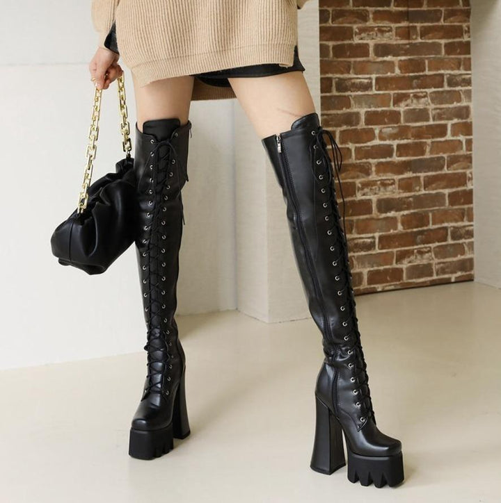 Edgy Women's Adora platform knee boots with high heel. Comfortable, waterproof, and sleek for bold versatile style.