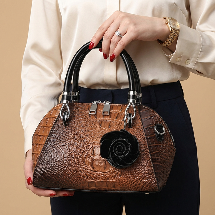 Women's alligator-texture statement handbag in luxe faux leather, a chic evening accessory.