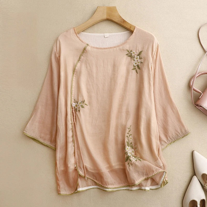 Women's Amber embroidered wrap blouse in peach & cream. Elegant long sleeve summer top, perfect for casual chic style.