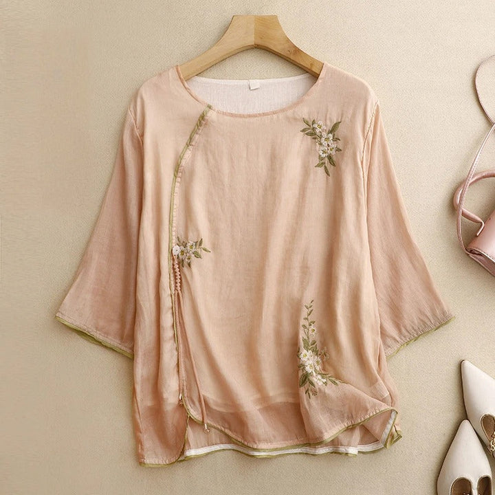 Women's Amber embroidered wrap blouse in peach & cream. Elegant long sleeve summer top, perfect for casual chic style.