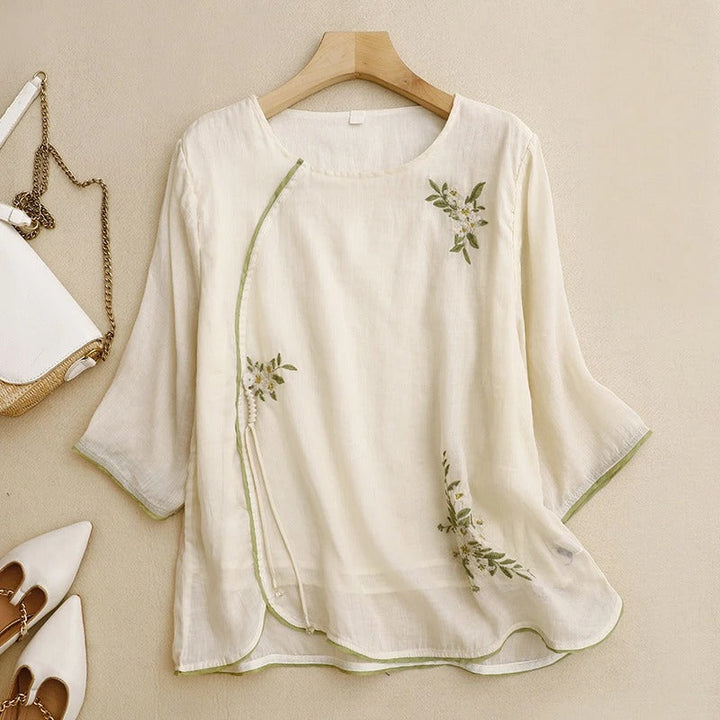 Elegant women's peach & cream embroidered wrap blouse. Long sleeve top, ideal for summer fashion & a casual chic look.