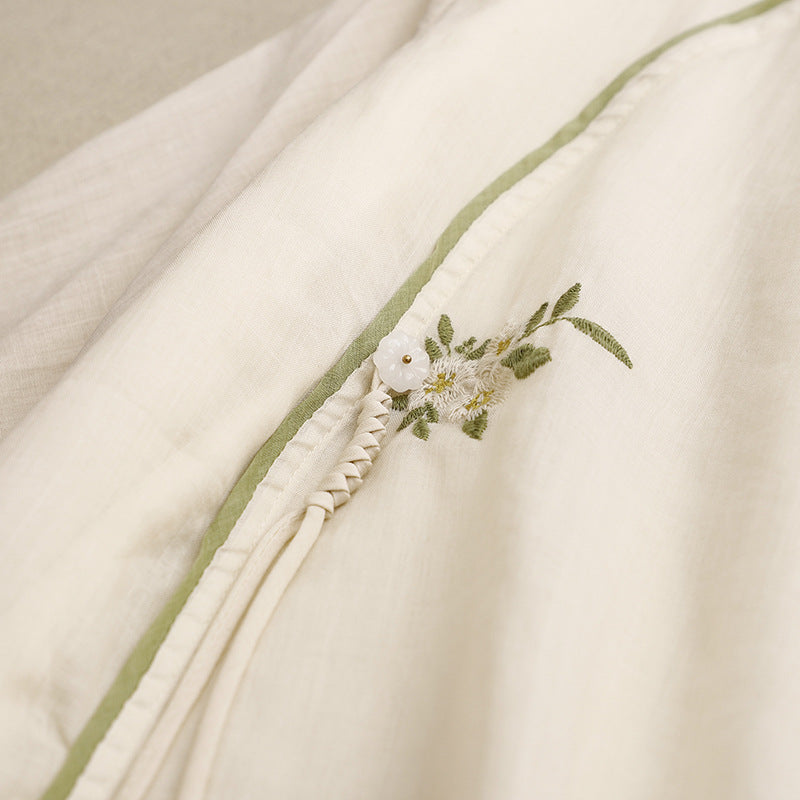 Amber embroidered wrap blouse for women, featuring peach & cream tones. Versatile long sleeve top for elegant summer wear.