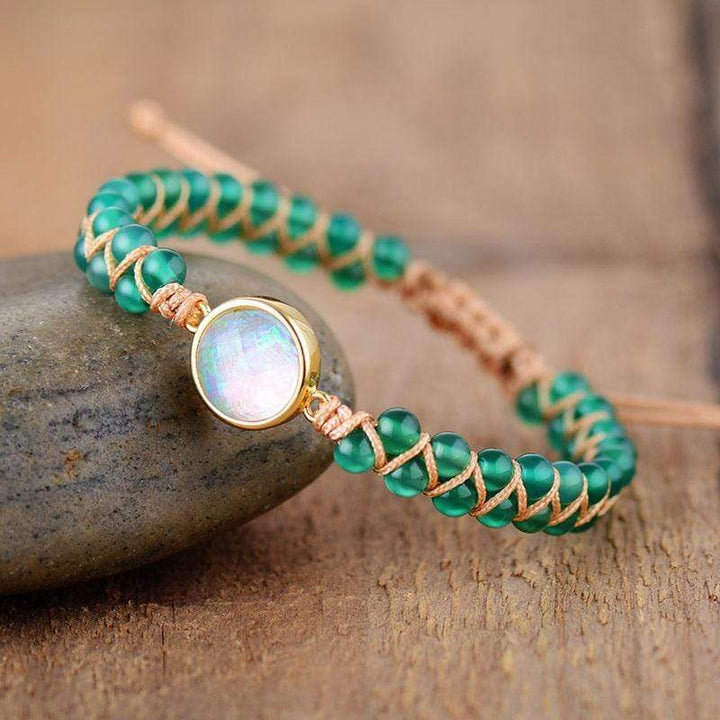 Close-up of a handcrafted women's yoga bracelet featuring vibrant amethyst and iridescent opal stones