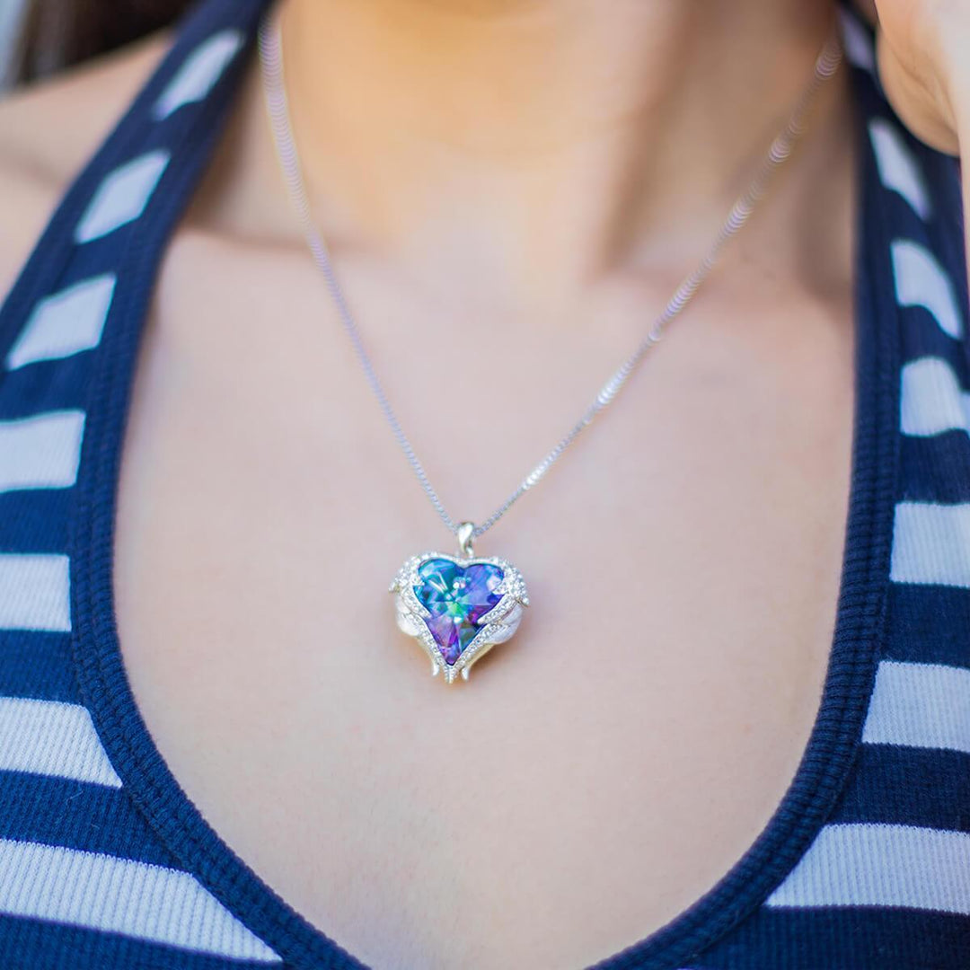 Detailed angel wing heart pendant necklace for women, sparkling crystals, representing love and a spiritual gift.