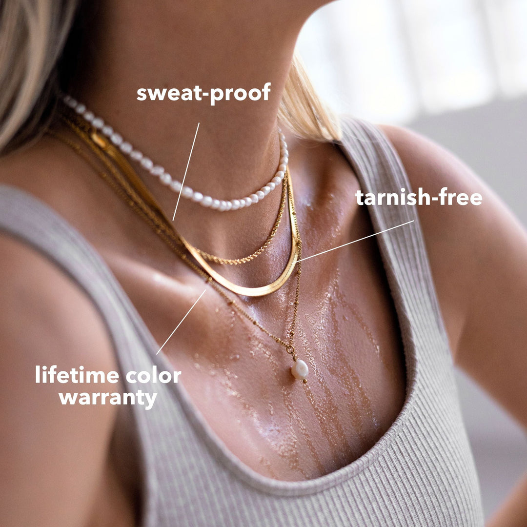 Delicate gold chain necklace with a naturally shaped baroque pearl, ideal for layering.