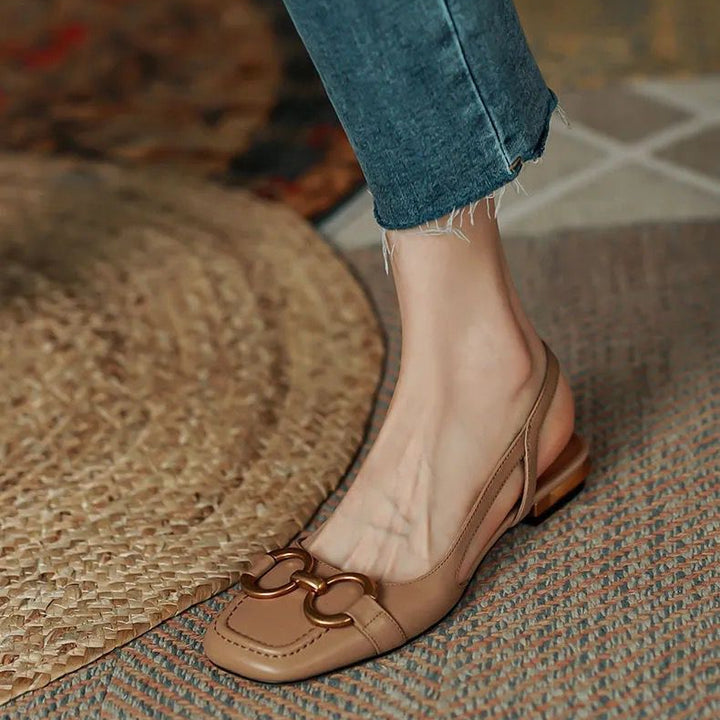 Elegant blue women's flats, slingback style with a supportive low heel, ideal for comfort and grace.