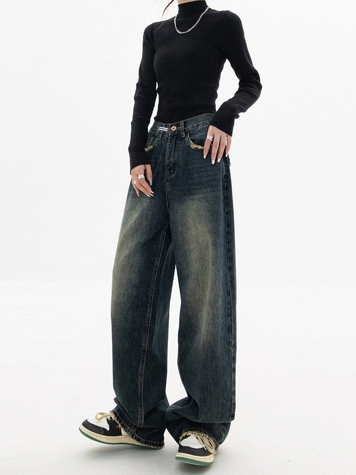 Full-length view of women's vintage baggy blue-gray jeans with a high waist and wide leg, styled for fashion.