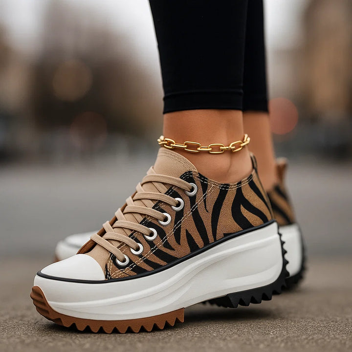 Women's Arlina Rise platform sneakers with black & white tiger print, lace-up design, and orthopedic comfort.