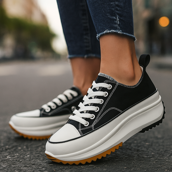 Side view of women's Arlina Rise platform sneakers with black tiger print, offering elevated comfort & casual style.