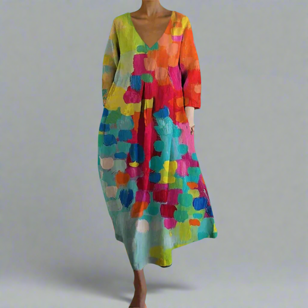 Women's artistic bohemian colorful maxi dress with flowing fabric & vibrant abstract print, perfect for summer vacations.
