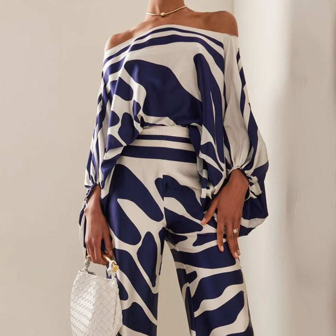 Elegant women's artistic print one-shoulder top and matching wide-leg pants set. Ideal for resort or summer events.