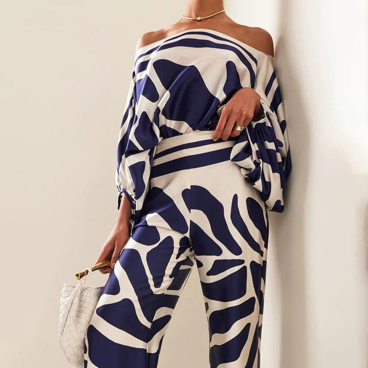 Flowy artistic print women's two-piece pants set featuring an asymmetrical one-shoulder top and comfortable wide legs.