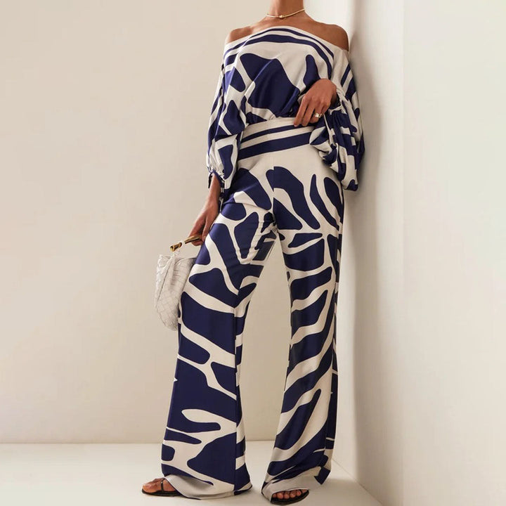Chic women's one-shoulder artistic print pants set. Versatile statement outfit for summer, vacation & resort wear.