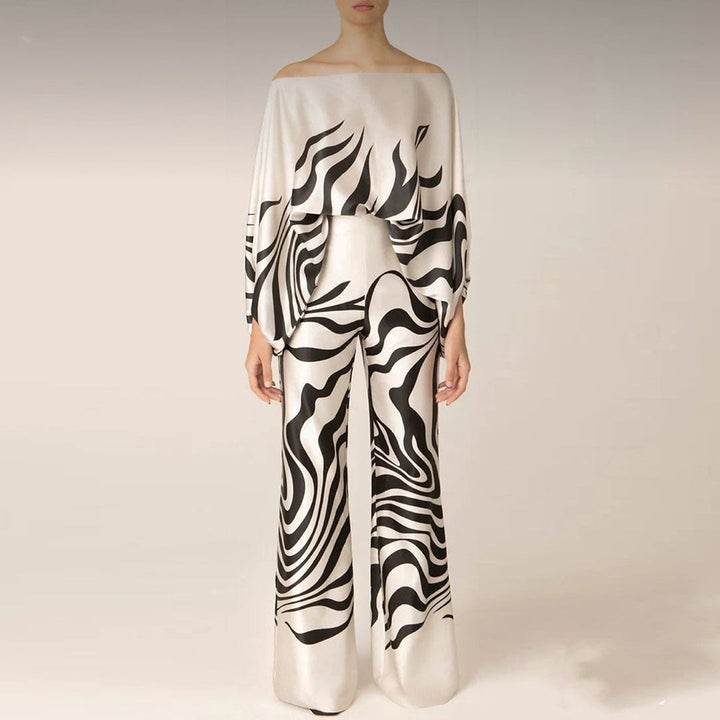 Modern women's two-piece artistic print set. One-shoulder top and wide-leg pants for a stylish, comfortable look.
