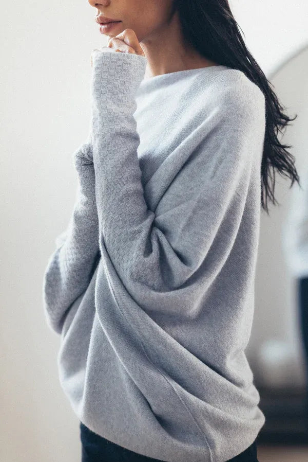 Women's asymmetric oversized sweater, comfortable and stylish for casual everyday wear.