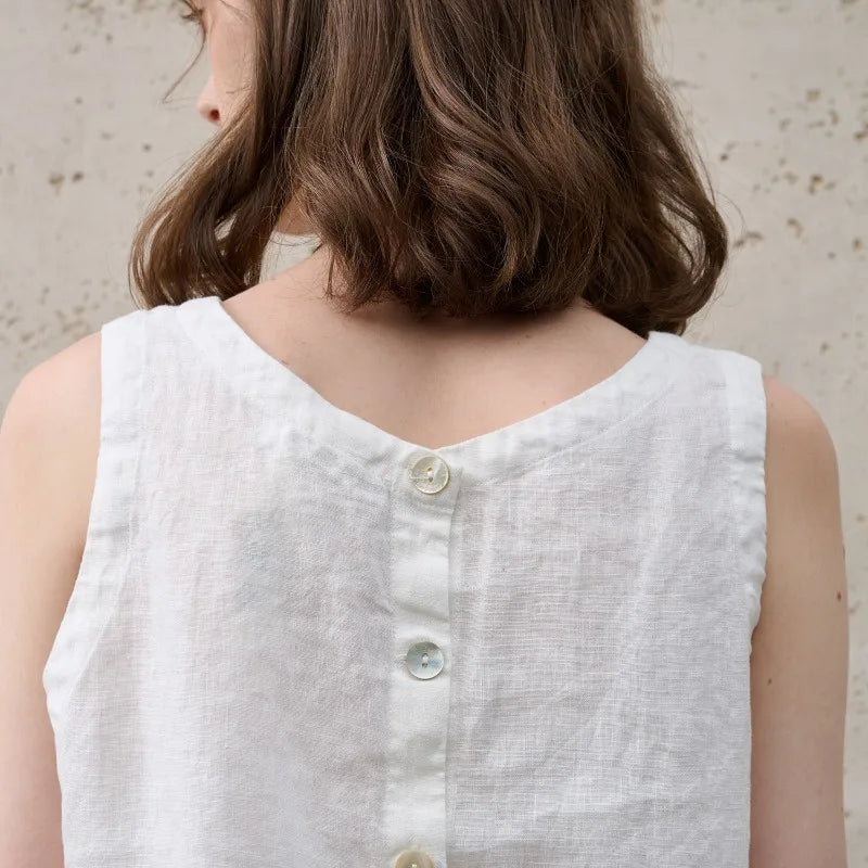Fashionable women's asymmetric sleeveless crew neck crop top, showcasing a trendy modern design.