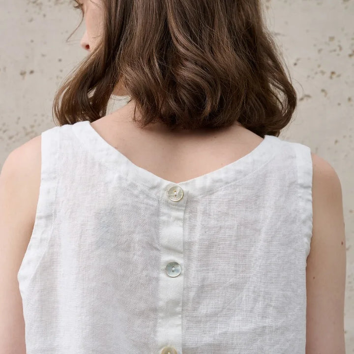 Fashionable women's asymmetric sleeveless crew neck crop top, showcasing a trendy modern design.
