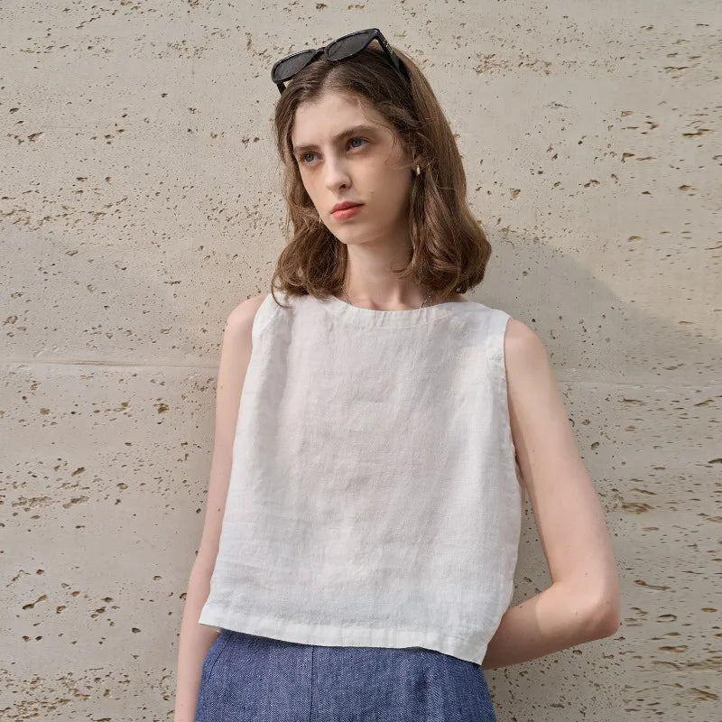 Chic women's sleeveless crop top with an asymmetric cut and crew neck, ideal for casual summer style.