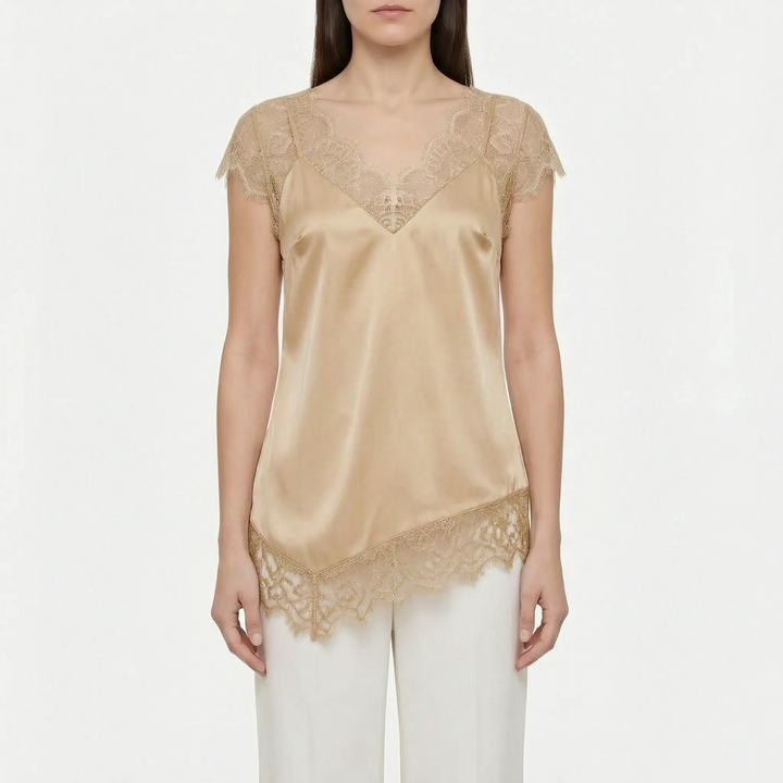 Chic sleeveless asymmetrical blouse with sheer detail. Perfect elegant top for evening events or a stylish casual look.