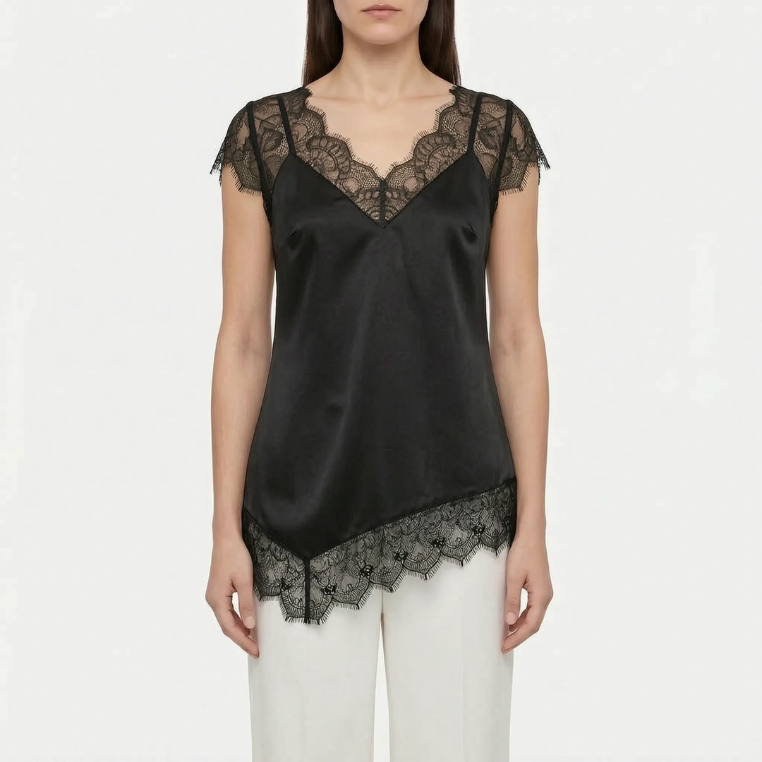 Relaxed fit asymmetrical blouse with sheer detail. Elegant women's top offering comfort & sophisticated style.
