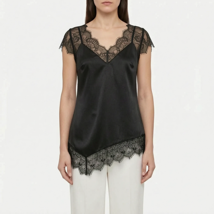 Relaxed fit asymmetrical blouse with sheer detail. Elegant women's top offering comfort & sophisticated style.