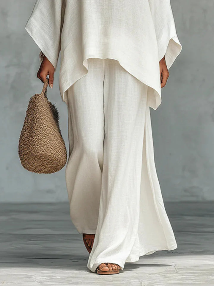 Flowy women's asymmetrical top & wide-leg pants two-piece set. Modern, comfortable travel outfit or casual wear.
