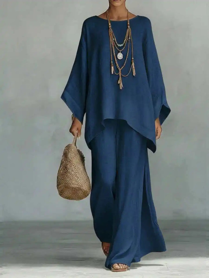 Women's casual two-piece travel outfit. Asymmetrical top and wide-leg pants set offers comfort & style.