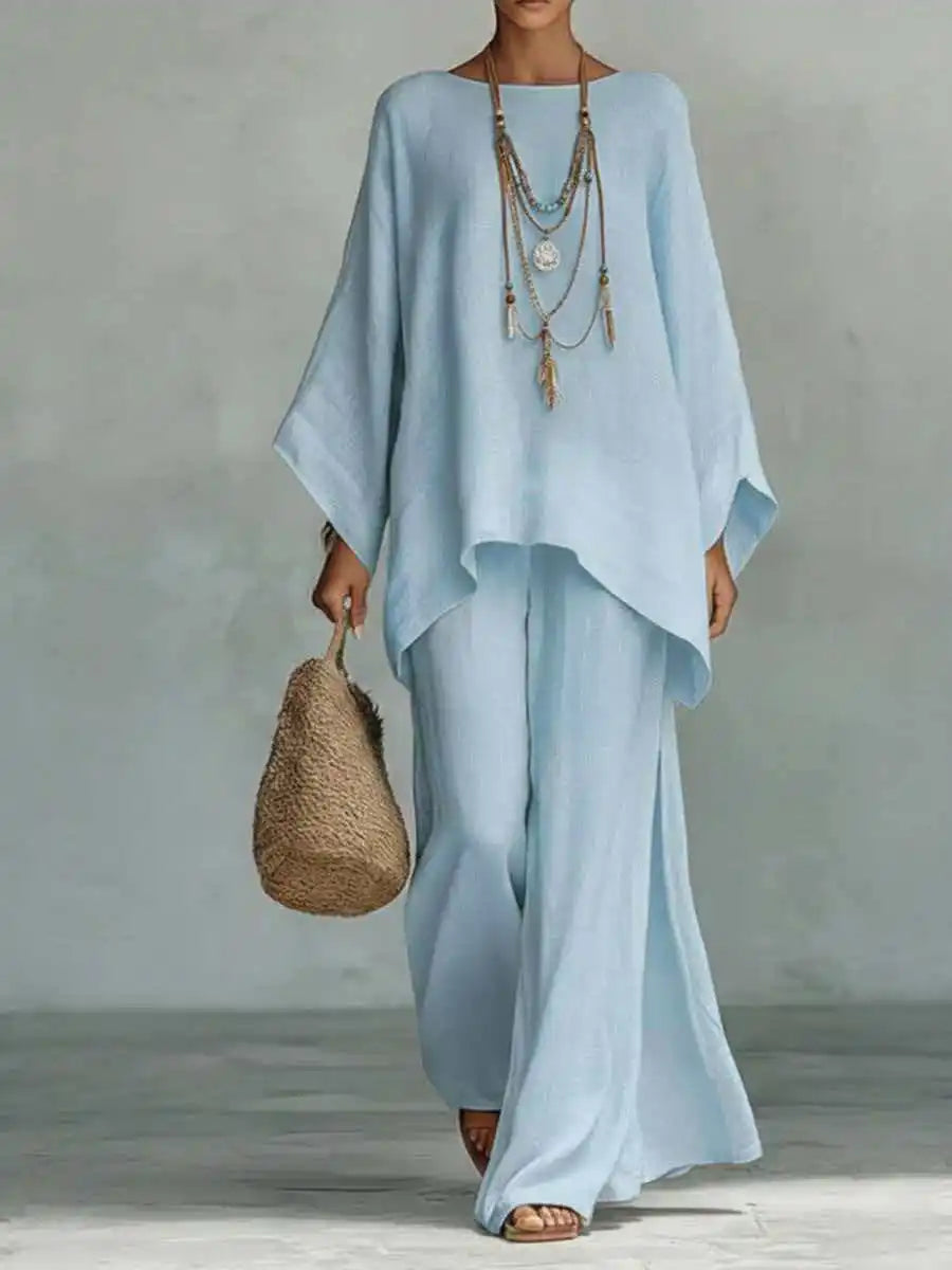 Chic women's asymmetrical two-piece set with a modern top & wide-leg pants. Versatile for casual & travel.