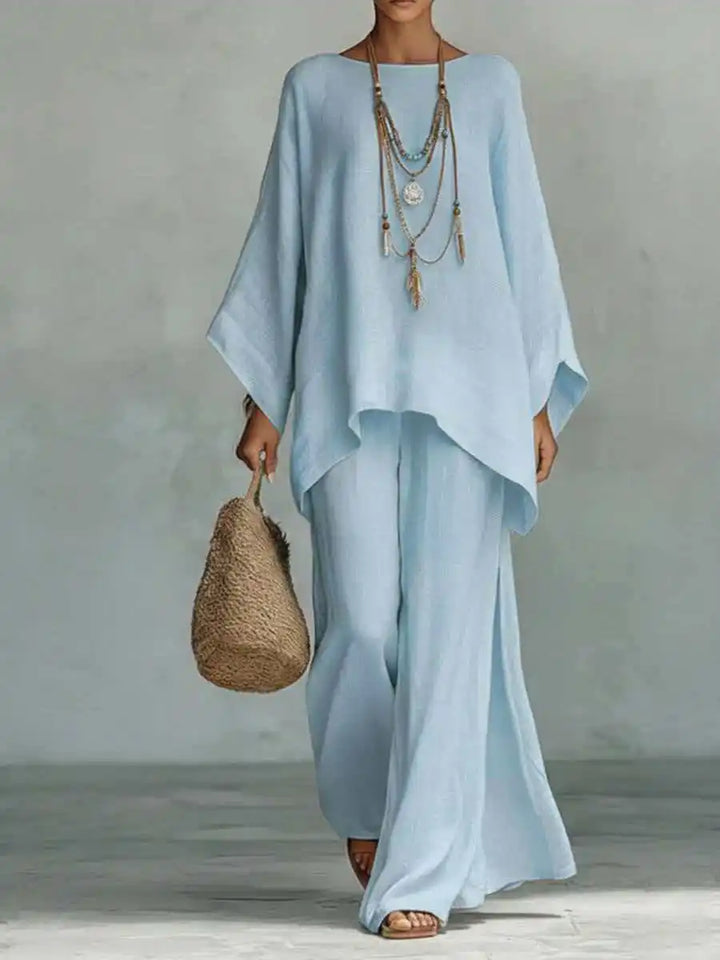 Chic women's asymmetrical two-piece set with a modern top & wide-leg pants. Versatile for casual & travel.