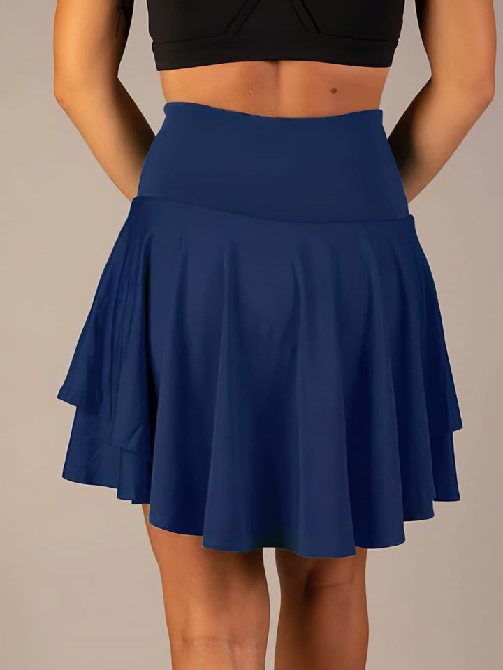 Performance women's tennis skirt, high-waisted, with built-in shorts for active wear.