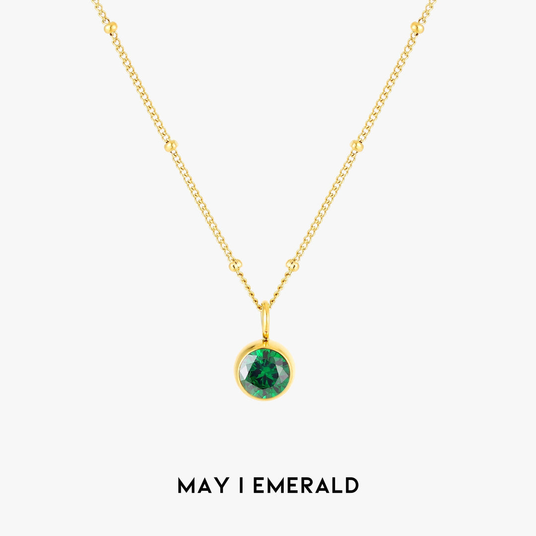 Close-up of personalized Aurora birthstone necklace, elegant women's gold jewelry.