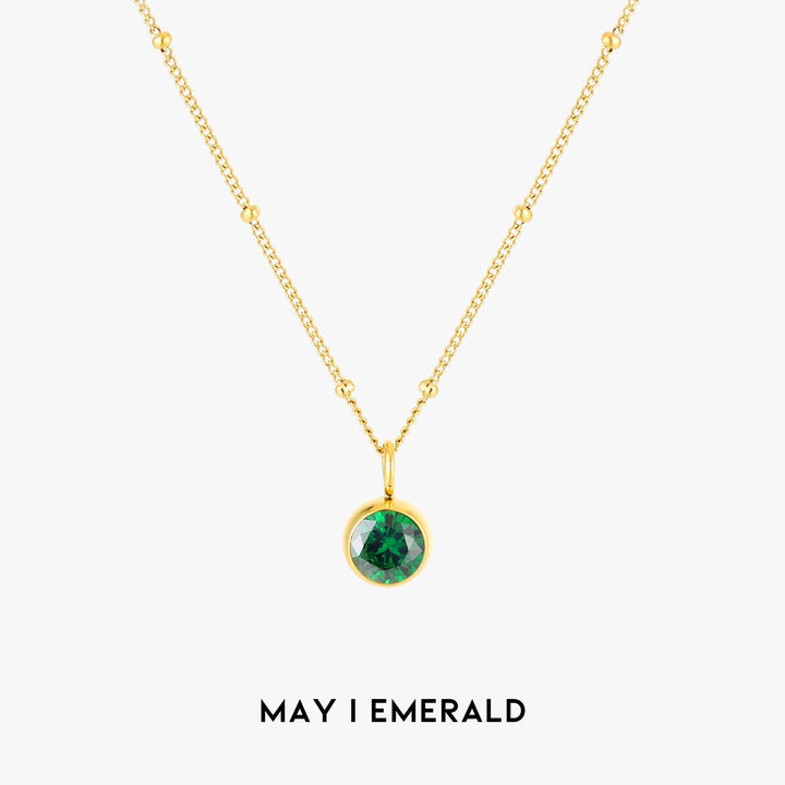 Close-up of personalized Aurora birthstone necklace, elegant women's gold jewelry.