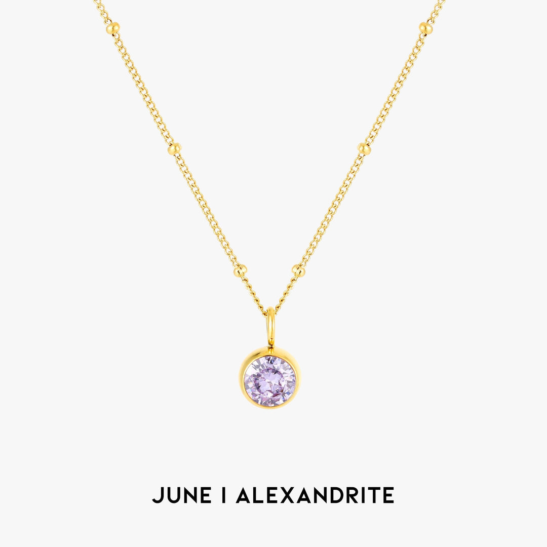 Women wearing an elegant silver Aurora birthstone necklace, custom gemstone jewelry.