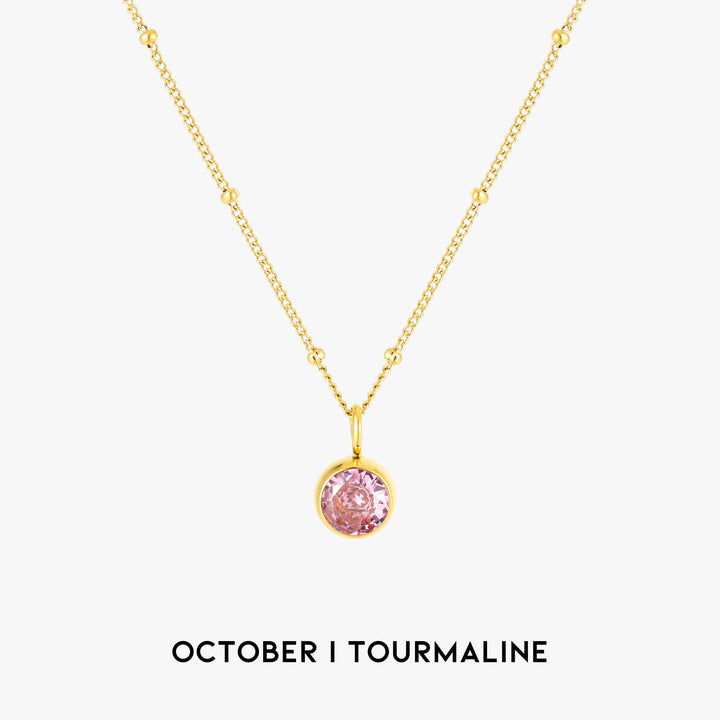 Detailed view of a personalized birthstone necklace, gold women's elegant jewelry.