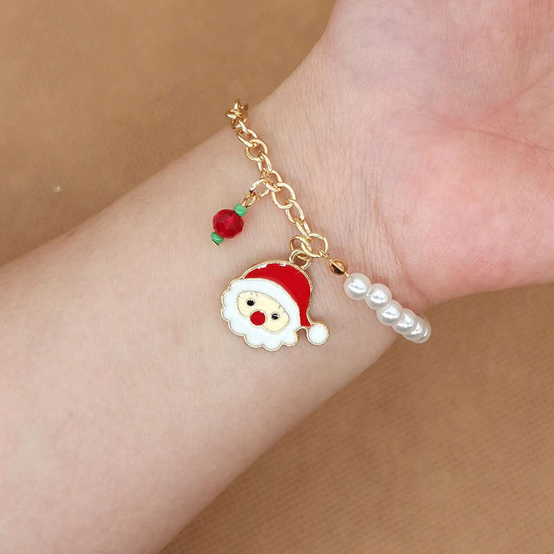 Stainless steel Australian Christmas charm bracelet featuring Santa, tree & snowflakes.